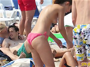 sizzling ample udders stripped to the waist inexperienced teens bikini Beach spycam